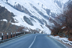 Empty road and mountains covered with snow